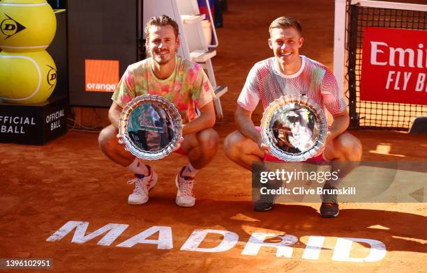 Wesley Koolhof of The Netherlands and Neal Skupski of Great Britain lift their Mutua Madrid Open winning trophies after their victory in the men's...