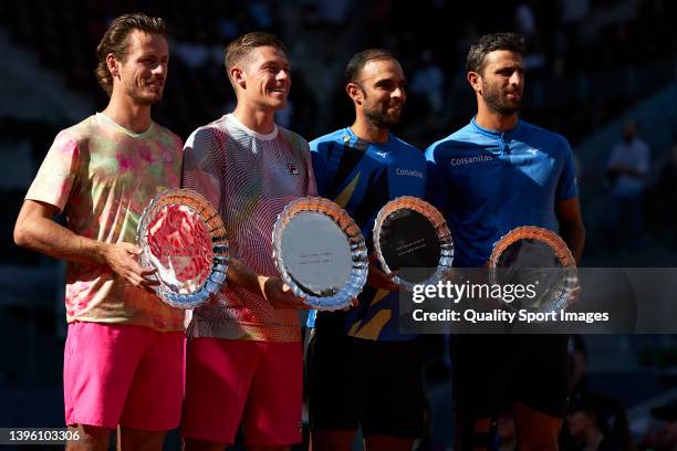 Wesley Koolhof of Netherlands and Neal Skupski of Great Britain hold the champions trophy together Sebastian Cabal of Colombia with partner Robert...