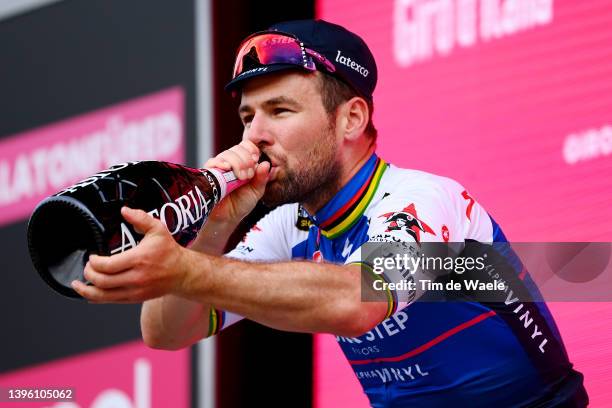Mark Cavendish of United Kingdom and Team Quick-Step - Alpha Vinyl celebrates winning the stage on the podium ceremony after the 105th Giro d'Italia...