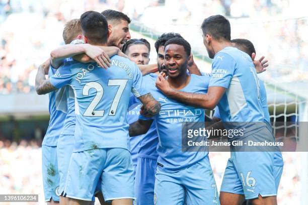Raheem Sterling of Manchester City celebrates with teammates after scoring his side's first goal during the Premier League match between Manchester...