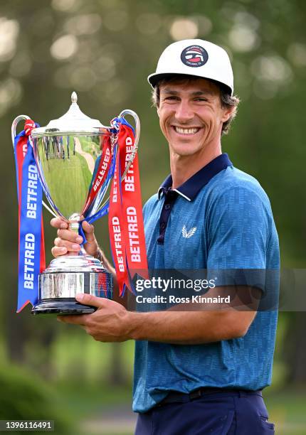 Thorbjorn Olesen of Denmark celebrates with the winners trophy after the final round of the Betfred British Masters hosted by Danny Willett at The...