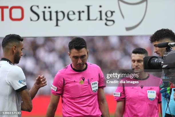 Referee Arda Kardeşler performs the pregame toss with a coin bearing the Bitcoin logo for a match between Beşiktaş and Fenerbahçe in the 36th week of...
