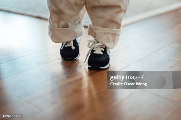 baby’s first step to walk on her own - kids feet in home stock pictures, royalty-free photos & images