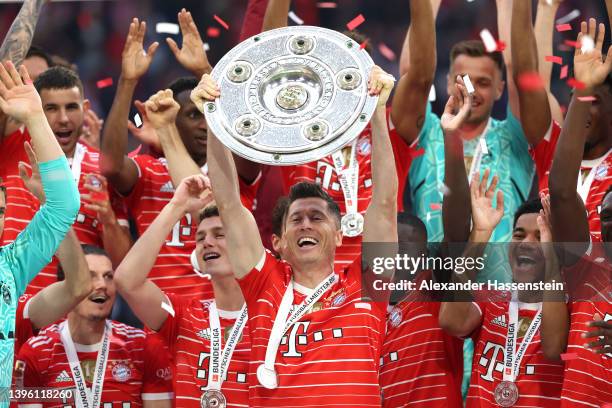 Robert Lewandowski of FC Bayern Muenchen lifts The Bundesliga Meisterschale trophy following their sides finish as the Bundesliga champions during...