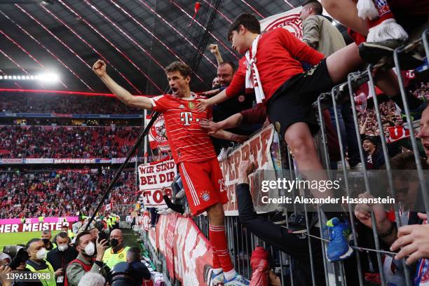 Thomas Mueller of FC Bayern Muenchen celebrates with the fans after their side finished the season as Bundesliga champions the Bundesliga match...