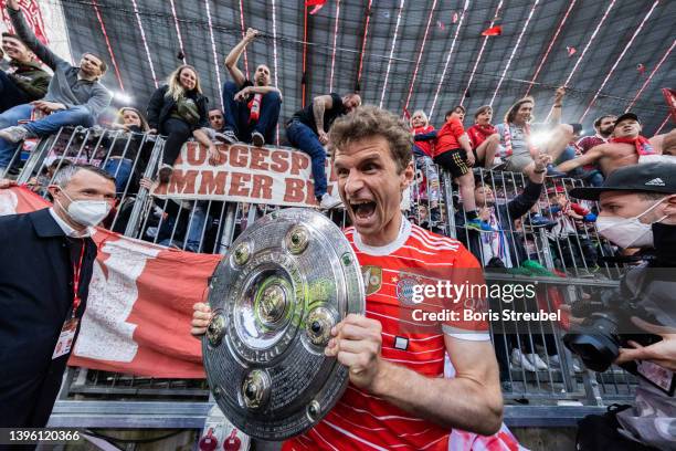 Thomas Mueller of FC Bayern Muenchen celebrates with the The Bundesliga Meisterschale trophy following their sides finish as Bundesliga champions...