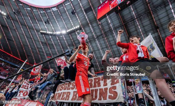 Thomas Mueller of FC Bayern Muenchen celebrates with his fans following their sides finish as Bundesliga champions after the Bundesliga match between...