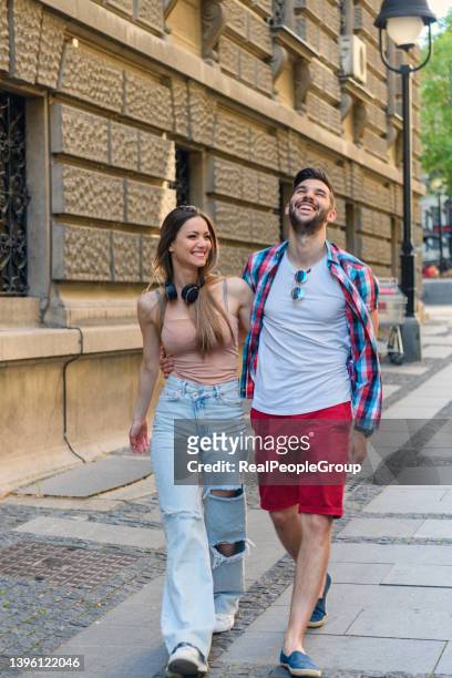 happy to be together. - guy girl street laugh stock pictures, royalty-free photos & images