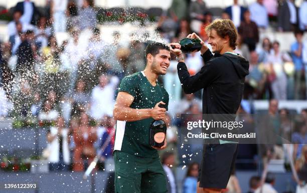 Alexander Zverev of Germany congratulates and pours champagne over Carlos Alcaraz Garfia of Spain after the men's singles final match at La Caja...