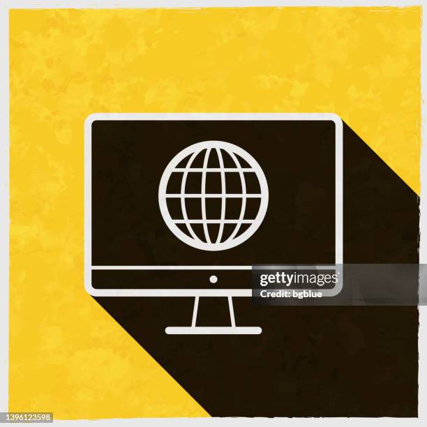 desktop computer with globe. icon with long shadow on textured yellow background - tv screen texture stock illustrations
