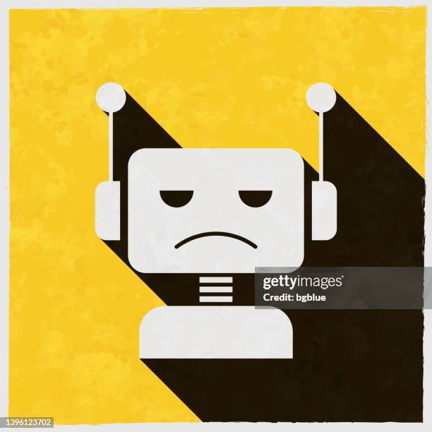 trauriger bot - roboterkopf. symbol mit langem schatten auf strukturiertem gelbem hintergrund - cyborg stock-grafiken, -clipart, -cartoons und -symbole