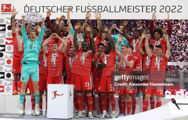 Manuel Neuer of FC Bayern Muenchen lifts The Bundesliga Meisterschale trophy following their sides finish as the Bundesliga champions during the...