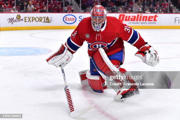 Carey Price of the Montreal Canadiens stops a shot by the Florida Panthers in the NHL game at the Bell Centre on April 29, 2022 in Montreal, Quebec,...