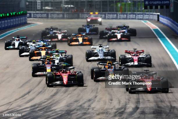 Charles Leclerc of Monaco driving the Ferrari F1-75 leads Max Verstappen of the Netherlands driving the Oracle Red Bull Racing RB18, Carlos Sainz of...