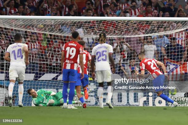 Yannick Carrasco scores their opening goal from a penalty shot as goalkeeper Andriy Lunin of Real Madrid CF misses the shot during the La Liga...