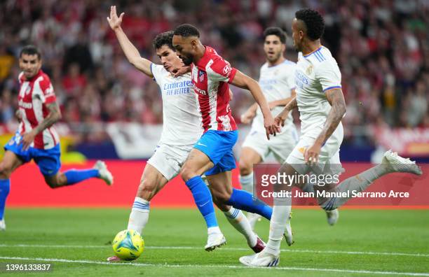 Jesus Vallejo of Real Madrid challenges Matheus Cunha of Atletico Madrid during the La Liga Santander match between Club Atletico de Madrid and Real...