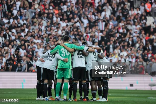 Kenan Karaman of Besiktas JK and Ersin Destanoglu of Besiktas JK and form a huddle with their team mates during the Turkish Super Lig match between...