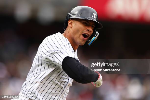 Gleyber Torres of the New York Yankees celebrates after hitting a walk-off home run in the bottom of the ninth inning to defeat the Texas Rangers 2-1...