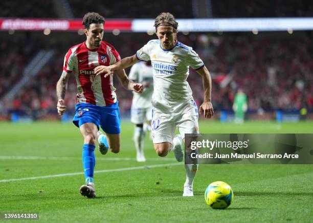 Luka Modric of Real Madrid battles with Sime Vrsaljko of Atletico Madrid during the La Liga Santander match between Club Atletico de Madrid and Real...