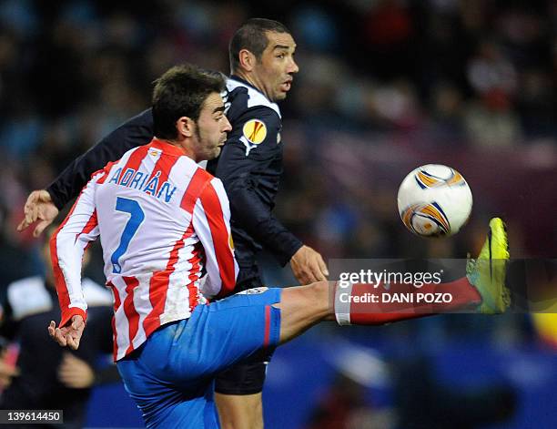 Atletico Madrid's forward Adrian Lopez Alvarez vies for the ball with Lazio's defender Andre Dias Goncalves during the UEFA Europa League football...