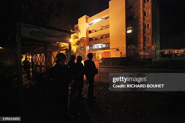 Anti-riot policemen patrol in the Chaudron district, on February 23, 2012 in Saint-Denis de la Reunion, on the French Reunion island, Indian Ocean,...