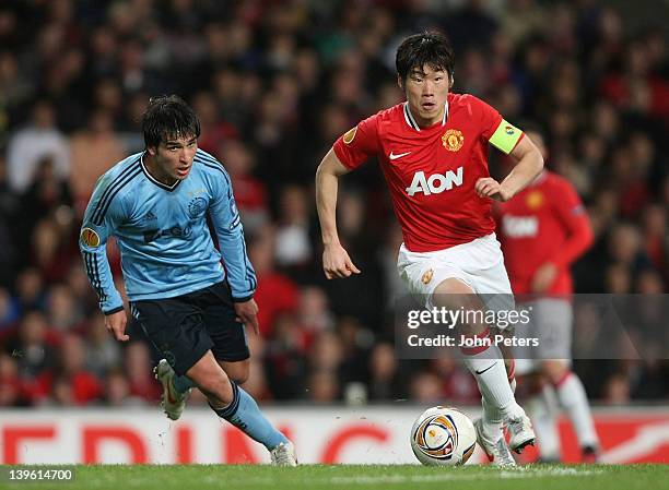 Ji-Sung Park of Manchester United clashes with Nicolas Lodeiro of AFC Ajax during the UEFA Europa League round of 32 second leg match at Old Trafford...