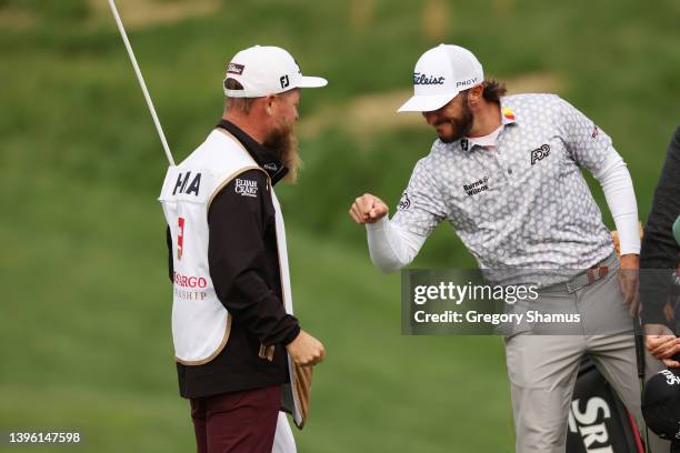 Max Homa of the United States celebrates with his caddie Joe Greiner after winning on the 18th green during the final round of the Wells Fargo...