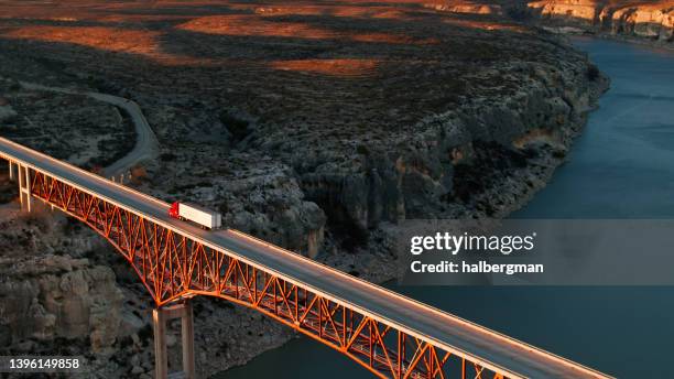 high angle drone shot of truck crossing pecos river bridge - lastbilstransport bildbanksfoton och bilder