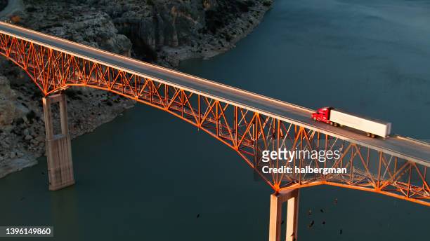high angle aerial shot of truck driving over pecos river bridge - heavy goods vehicle stockfoto's en -beelden