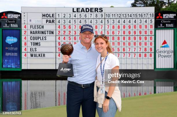 Steve Flesch poses with the trophy and his daughter Lily after winning the Mitsubishi Electric Classic at TPC Sugarloaf Golf Course on May 08, 2022...