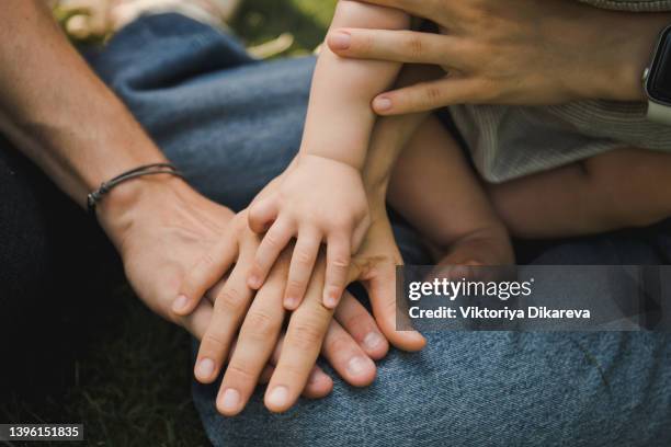 family stacking hands. - three people bildbanksfoton och bilder