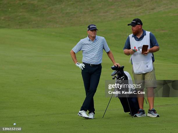 Steve Flesch converses with his caddie on the 17th hole during the final round of the Mitsubishi Electric Classic at TPC Sugarloaf Golf Course on May...