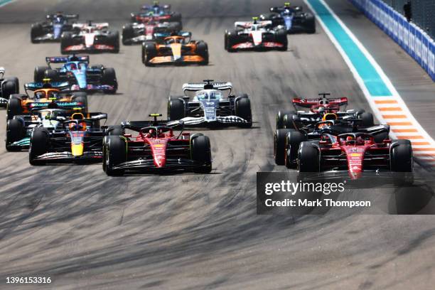 Charles Leclerc of Monaco driving the Ferrari F1-75 leads the field at the start of the race during the F1 Grand Prix of Miami at the Miami...