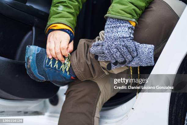 unrecognizable tourist tying shoelaces in car - lace glove fotografías e imágenes de stock