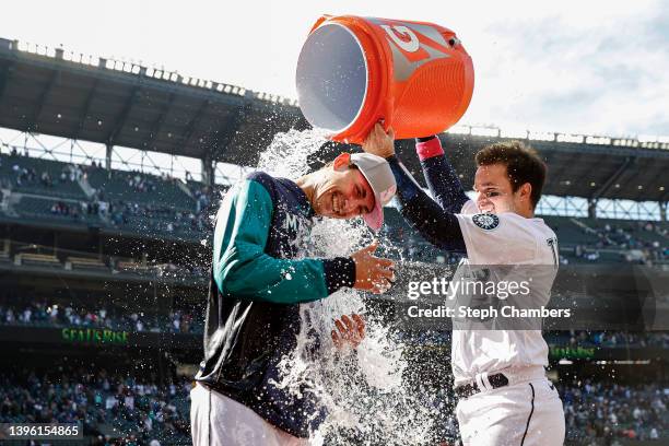 Luis Torrens douses George Kirby of the Seattle Mariners with water after beating the Tampa Bay Rays 2-1 during the tenth inning at T-Mobile Park on...