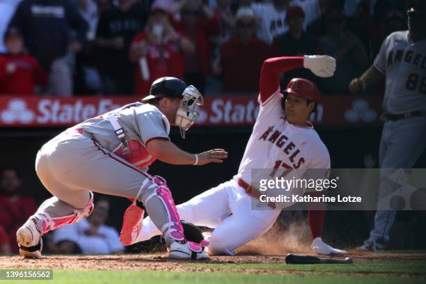 Shohei Ohtani of the Los Angeles Angels scores against Riley Adams of the Washington Nationals in the ninth inning at Angel Stadium of Anaheim on May...