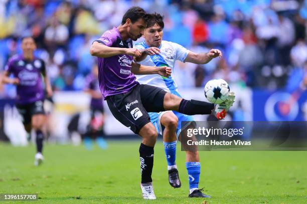 Oswaldo Alanis of Mazatlan FC fights for the ball with Martin Barragan of Puebla during the playoff match between Puebla and Mazatlan FC as part of...