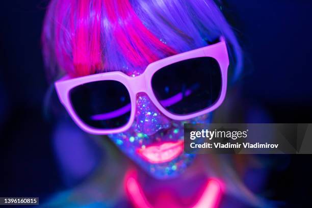 portrait of a young girl under uv lights - techno music stock pictures, royalty-free photos & images