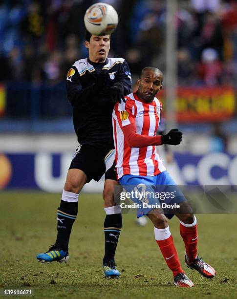 Luis Perea of Club Atletico de Madrid battles for the ball against Hernanes of S.S. Lazio during the UEFA Europa League Round of 32 second leg match...