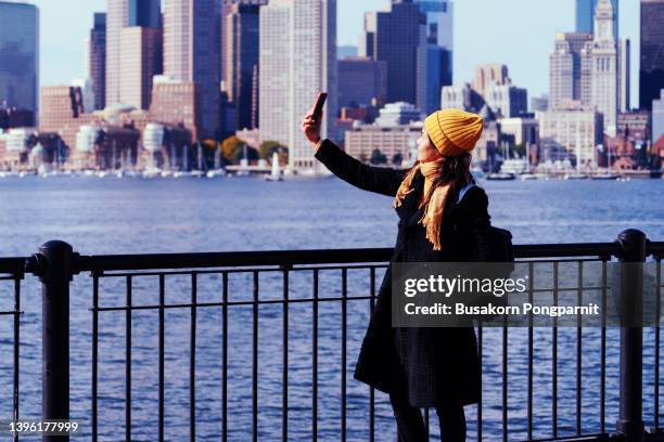 mid adult woman standing by cityscape, boston usa - boston women ストックフォトと画像