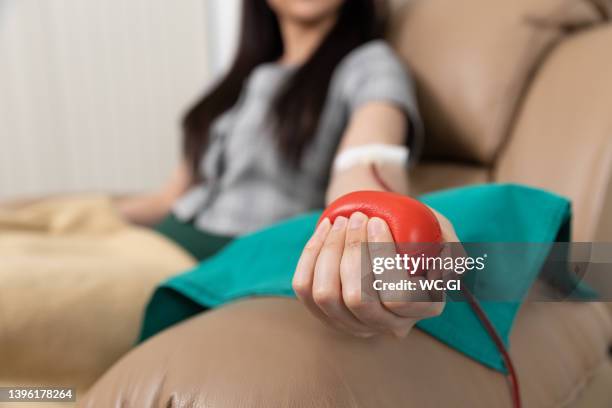 close up of hand women squeeze the ball. blood donation - blood donation imagens e fotografias de stock