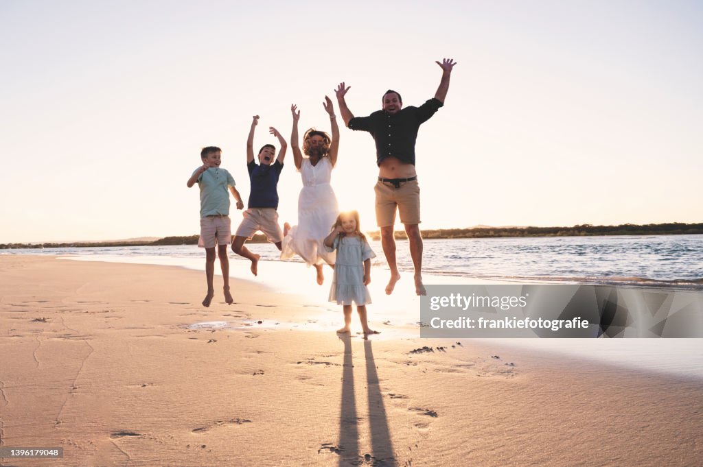 Family Jumping at Sunset