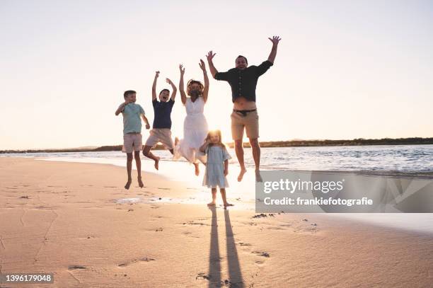 family jumping at sunset - family photo shoot stock pictures, royalty-free photos & images