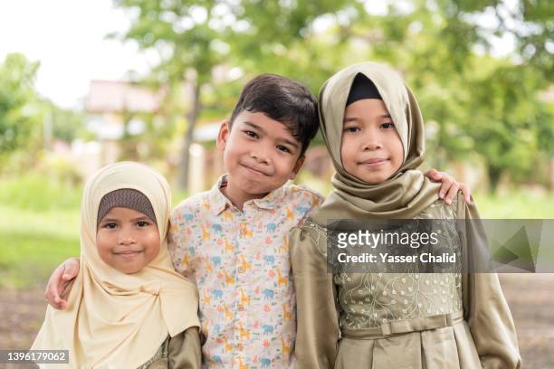 portrait of muslim kids at a park outdoors - インドネシア人 ストックフォトと画像
