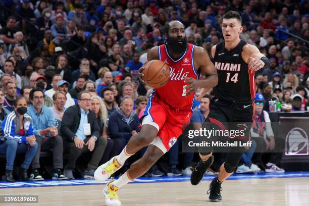 James Harden of the Philadelphia 76ers drives to the basket against Tyler Herro of the Miami Heat during Game Four of the 2022 NBA Playoffs Eastern...