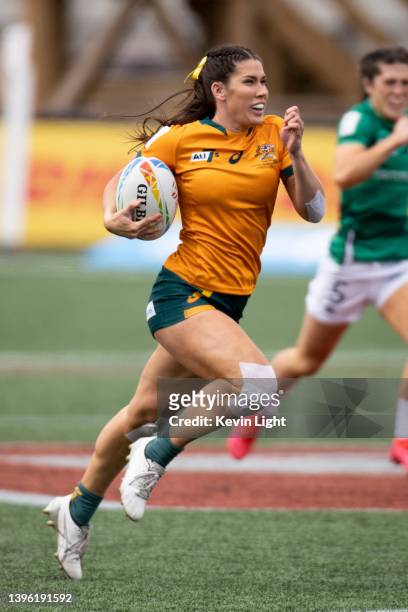 Charlotte Caslick of Australia runs with the ball against Ireland during a Women's HSBC World Rugby Sevens Series match at Starlight Stadium on May...