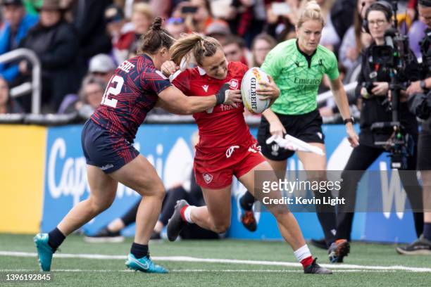 Krissy Scurfield of Canada runs with the ball against Kristi Kirshe of team USA during a Women's HSBC World Rugby Sevens Series match at Starlight...