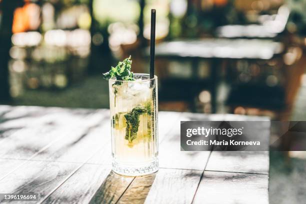 summer cold drink, lemonade on table in sunny day. - mojito stock pictures, royalty-free photos & images