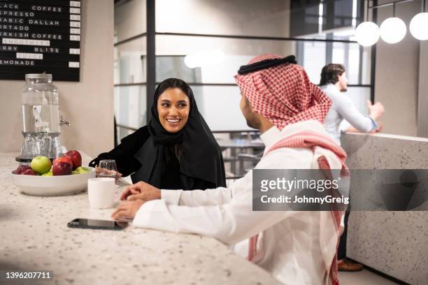 young middle eastern business associates taking a break - saudi relaxing stock pictures, royalty-free photos & images