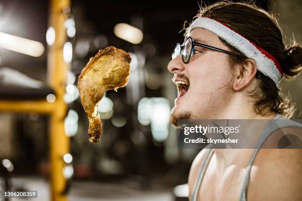 craving for chicken meat in a gym! - funny rooster stockfoto's en -beelden